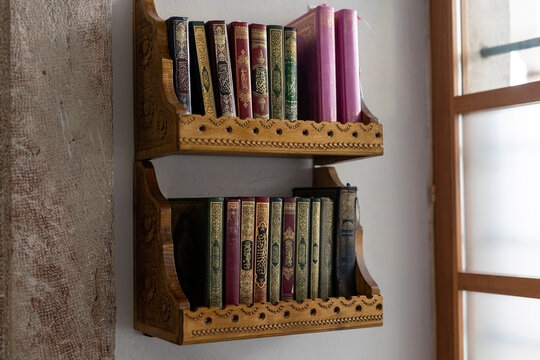 shelves in the mosque filled with a Quran