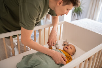 Father calming little baby for sleep
