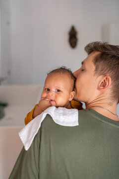 Father holding baby for burping