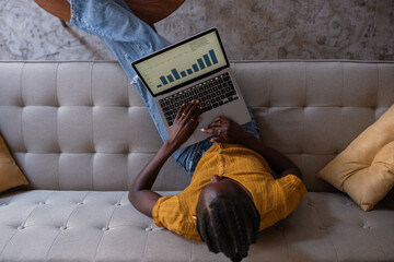 Woman looking at growing bar chart on laptop