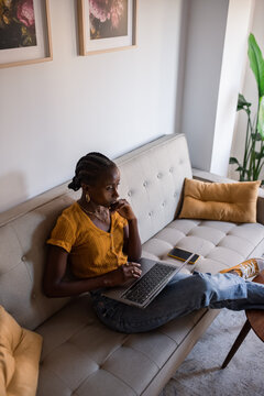 Woman thinking while using laptop