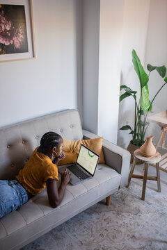 Woman working on laptop near humidifier