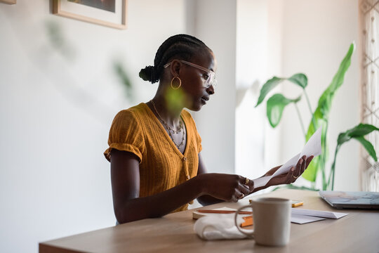 Woman doing paperwork at home office