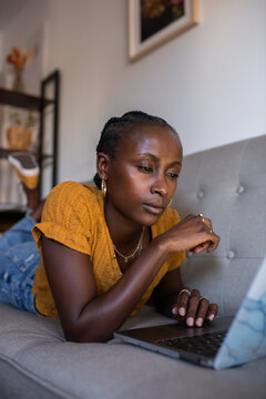 Woman reading information on laptop with interest