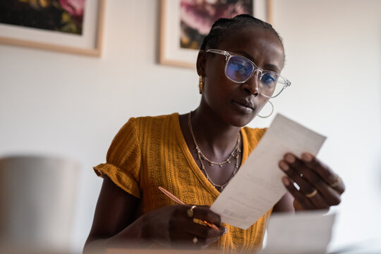 Focused woman checking receipts