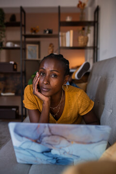 Pretty woman looking at camera at home