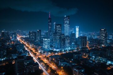 Obraz premium Illuminated urban skyline at night reveals city's vibrant, bustling energy, showcasing towering skyscrapers, dynamic traffic patterns, and a sense of technological advancement and modernity.