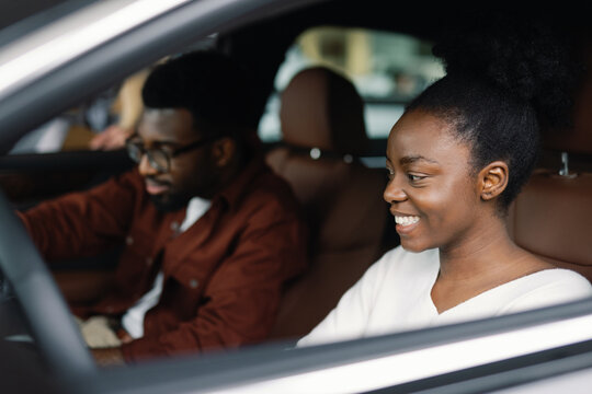 Female car buyer getting ready for test drive with her companion