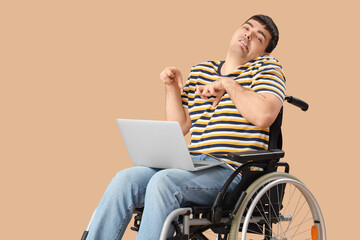 Young man in wheelchair with laptop on brown background. National Cerebral Palsy Awareness Month