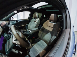 The inside of a car with the sunroof open