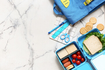 Lunch box with tasty food and school backpack with stationery on white background