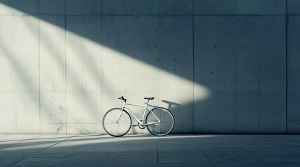 White bicycle parked against a concrete wall with sunlight beams. - Powered by Adobe