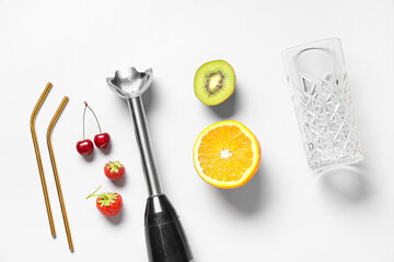 Hand blender and different ingredients for preparing fresh smoothie on white background