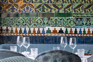 Restaurant in Triana district, Sevilla, served for lunch or dinner empty tables with walls covered with traditional Sevillian ceramic tiles