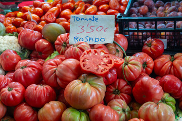 Vegetables of Spain, farmers organic ripe rose tomatoes from Navarra on local market, tomate rosado means pink tomatoes