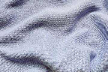 Knitted pure cotton fabric of light blue color. Knit texture.