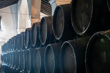 Solera system in old Andalusian wine cellar, process for aging sherry wine in barrels, fino, manzanilla, olorosso, amontillado jerez fortified wine, Sanlucar de Barrameda, Cadiz, Andalusia, Spain