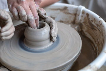Making of mud pot on potters wheel during workshop in art ceramic atelier in Poland