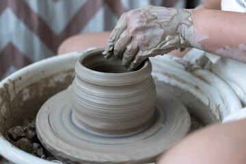 Making of mud pot on potters wheel during workshop in art ceramic atelier in Poland