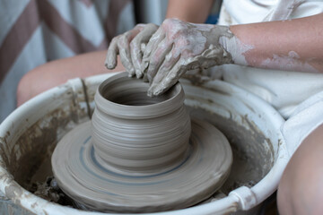 Making of mud pot on potters wheel during workshop in art ceramic atelier in Poland