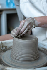 Making of mud pot on potters wheel during workshop in art ceramic atelier in Poland