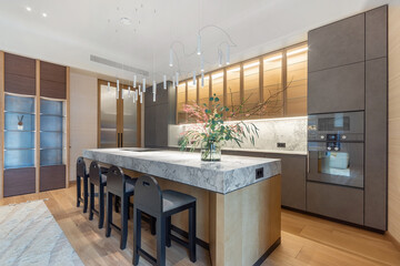 Cozy kitchen interior with exclusive design. Stylish kitchen set. Beautiful flower .arrangement in a vase on the table.