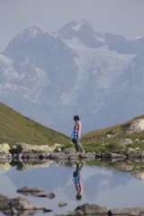 Obraz premium Peaceful Mountain Reflection with Hiker in Alpine Landscape VSCO