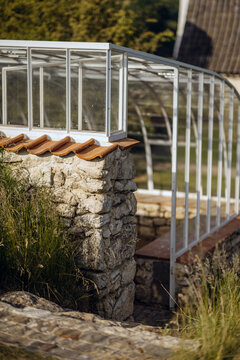 Detailed shot of a greenhouse and stone wall