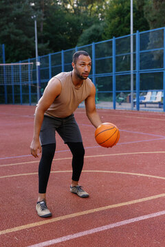 Basketball player standing on court before making scoop shot