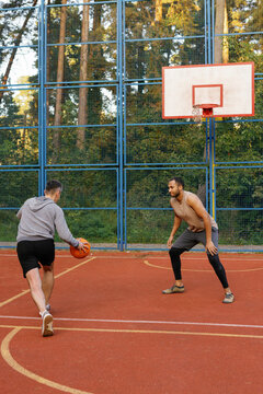 Defender attempting to stop offensive player from dribbling ball