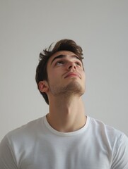 Fototapeta premium Contemplative Man in White Shirt