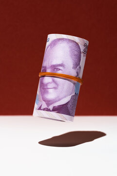 Turkish lira money roll hovering on red and white background
