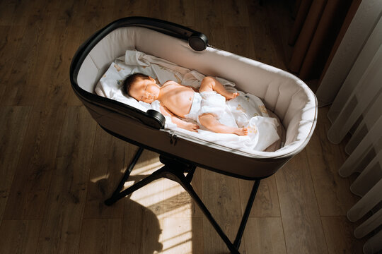 the newborn lies in the sun and gets vitamin D.