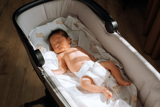 the newborn lies in the sun and gets vitamin D.
