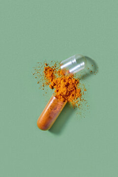 Translucent medical capsule with orange powder dropping out