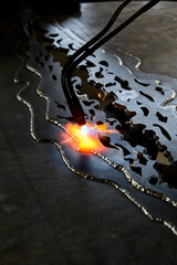 Close up view of heated metal and anvil. Blacksmith in the production process of other metal products handmade in the forge. Metalworker forging metal . Metal craft industry. texture
