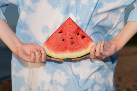 Hands Holding a Slice of Watermelon