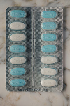 blue and white Mucinex tablets in pack