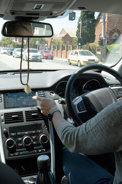 Person using navigation system while driving in an urban area