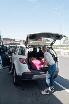 Loading a suitcase into a car at the Melbourne airport