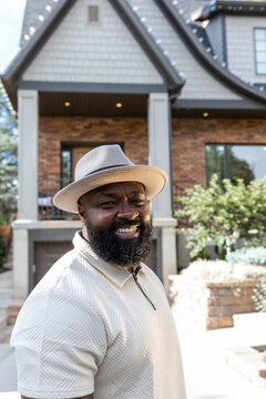African American man alone portrait Looking at camera hat profile