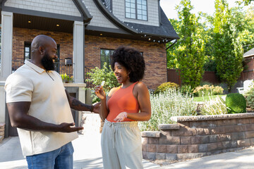 African American family portrait with keys to new home 
