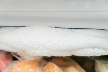 A lot of ice inside a fridge, freezer needs to be defrosted
