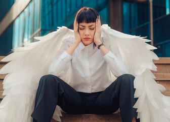 A contemplative moment captured in urban surroundings with angelic wings embracing introspection...