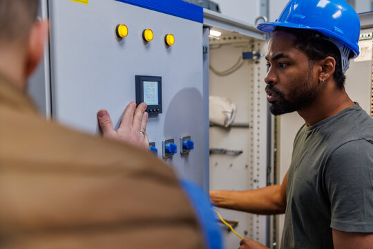 Technician and engineer discussing over machine