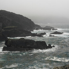 waves crashing on cliffs on a rainy day, on the West Coast of Irland. 