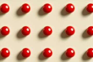 Pattern of shiny red spheres creating a repetitive design on yellow background
