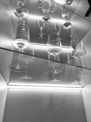 Glass cabinet with different glasses and glasses, all illuminated by built-in lighting