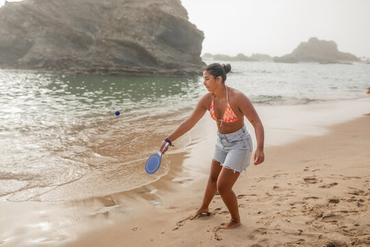 woman enjoying time on a beach in Portugal. 