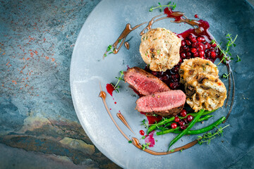 Traditionally roasted fillet of saddle of venison with bread dumplings, mushrooms and bean sticks...